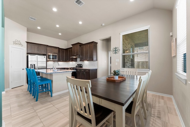 dining room featuring vaulted ceiling, baseboards, visible vents, and recessed lighting