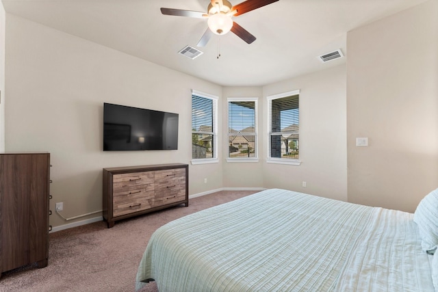 carpeted bedroom featuring ceiling fan, visible vents, and baseboards