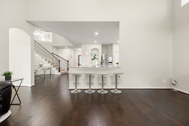 interior space featuring recessed lighting, dark wood finished floors, stairway, and baseboards