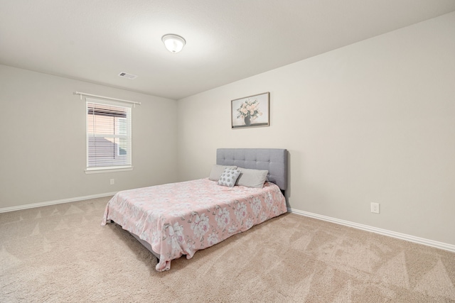 bedroom with light carpet, baseboards, and visible vents