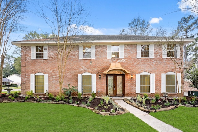 colonial-style house with french doors and a front lawn