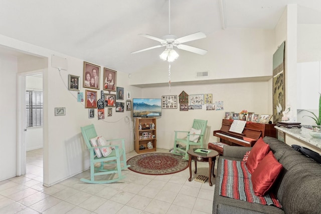 tiled living room featuring ceiling fan and vaulted ceiling