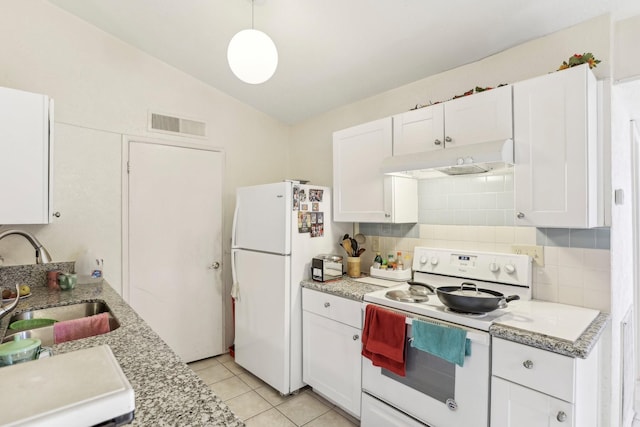 kitchen with white appliances, white cabinetry, sink, and vaulted ceiling