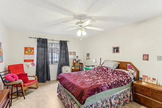 bedroom with ceiling fan and a textured ceiling