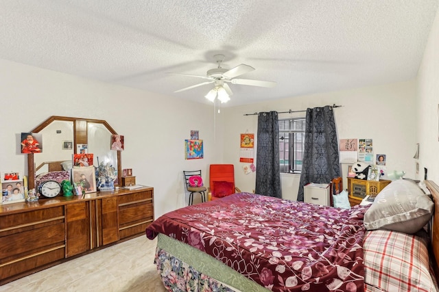 bedroom with a textured ceiling and ceiling fan