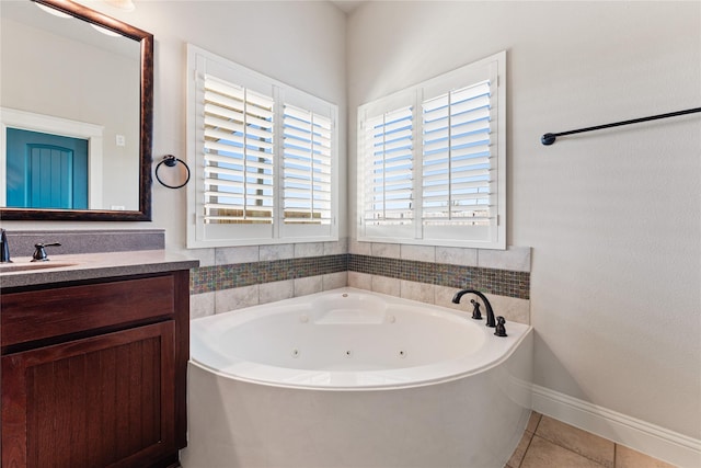 bathroom featuring a bath, tile patterned flooring, and vanity