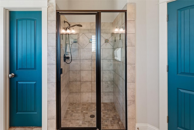 bathroom with a shower with door