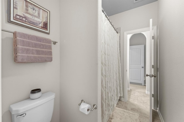 full bath featuring toilet, baseboards, and tile patterned floors