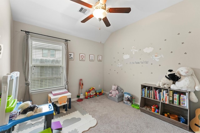 recreation room featuring lofted ceiling, carpet flooring, a ceiling fan, visible vents, and baseboards