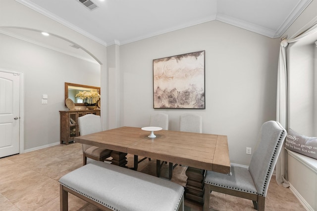 dining area featuring light tile patterned floors, arched walkways, visible vents, baseboards, and crown molding