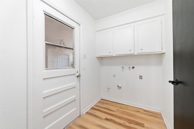 laundry area featuring cabinets, hookup for a gas dryer, and light hardwood / wood-style floors