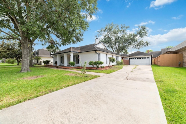 view of front of property featuring a front yard and a garage