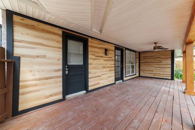 wooden terrace with ceiling fan and a porch