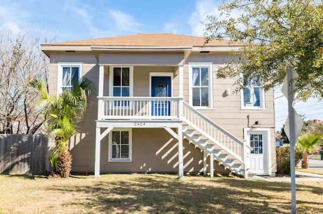 rear view of property featuring a lawn