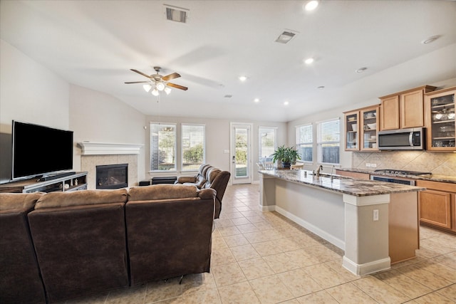 kitchen featuring decorative backsplash, stainless steel appliances, plenty of natural light, and sink