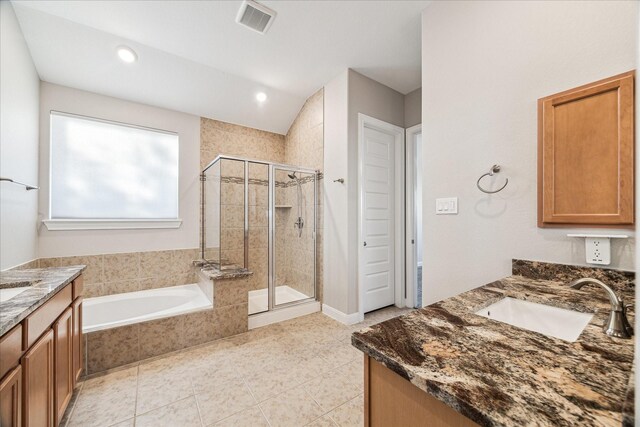 bathroom featuring independent shower and bath, tile patterned flooring, and vanity