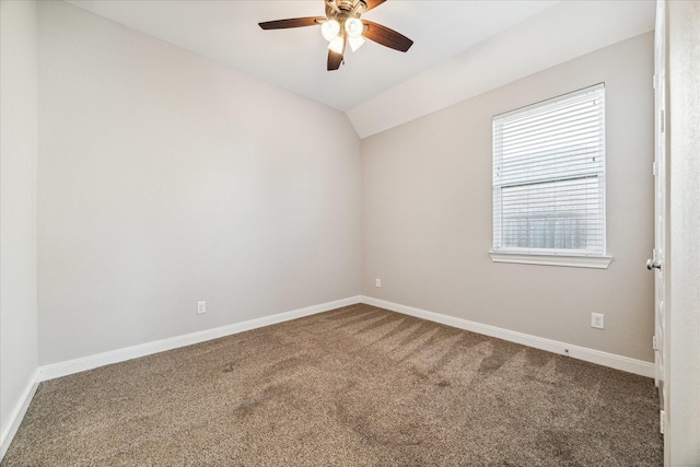 carpeted empty room with ceiling fan and vaulted ceiling