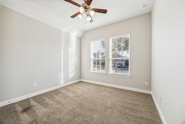 carpeted spare room featuring lofted ceiling and ceiling fan