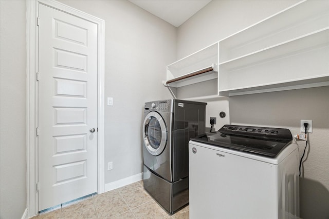 washroom featuring light tile patterned floors and washer and dryer