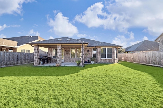 rear view of property with a patio area and a lawn