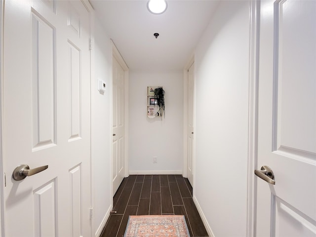 hall featuring wood finish floors and baseboards