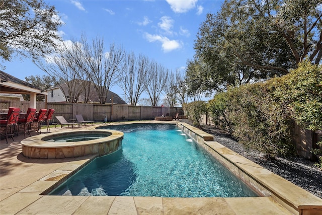 view of swimming pool with pool water feature, an in ground hot tub, and a patio area