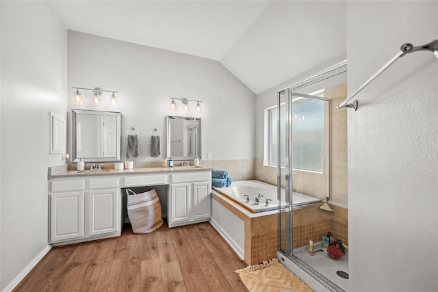 bathroom featuring separate shower and tub, vaulted ceiling, wood-type flooring, and vanity