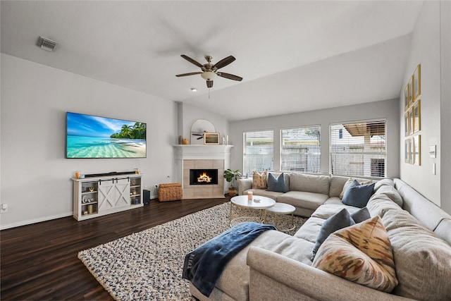 living room with a fireplace, lofted ceiling, dark hardwood / wood-style floors, and ceiling fan