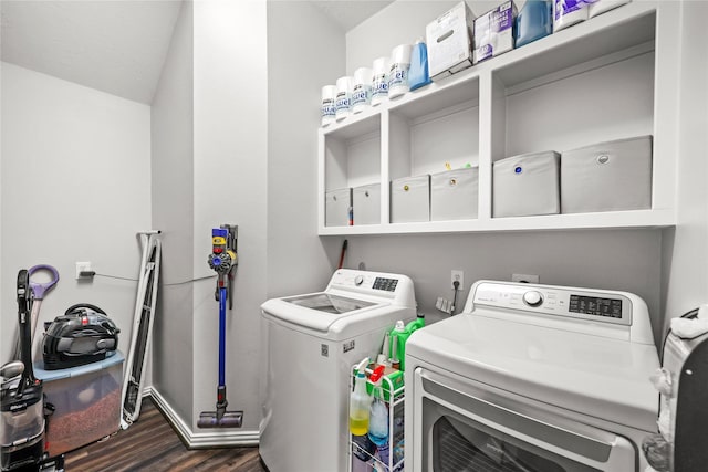 washroom with washer and dryer and dark wood-type flooring