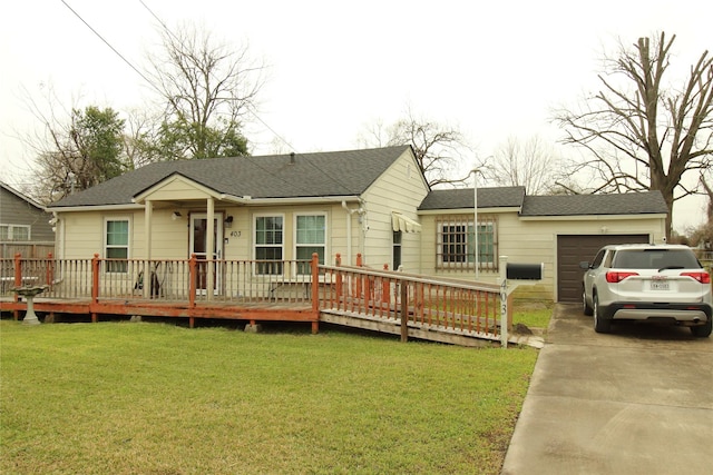 ranch-style home featuring a garage, driveway, a shingled roof, and a front lawn