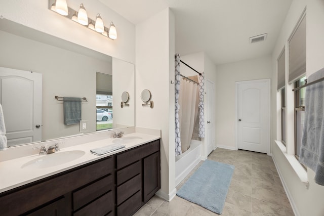 bathroom with tile patterned flooring, vanity, and shower / bathtub combination with curtain