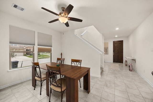 tiled dining area featuring ceiling fan