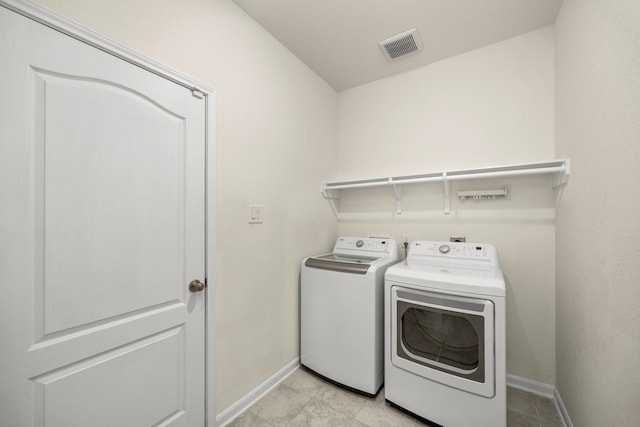 clothes washing area featuring washing machine and dryer