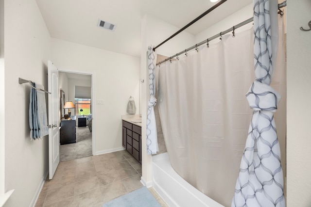 bathroom featuring tile patterned floors, vanity, and shower / tub combo