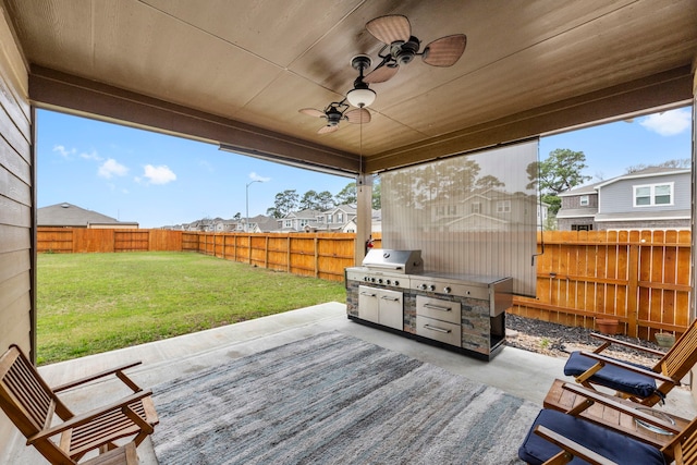 view of patio with area for grilling and ceiling fan