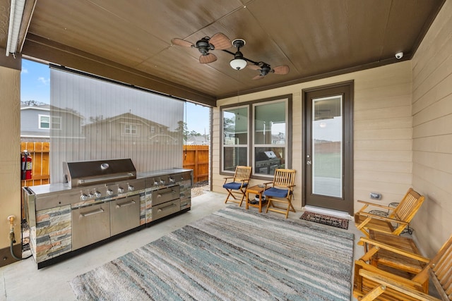 view of patio / terrace featuring ceiling fan, grilling area, and exterior kitchen