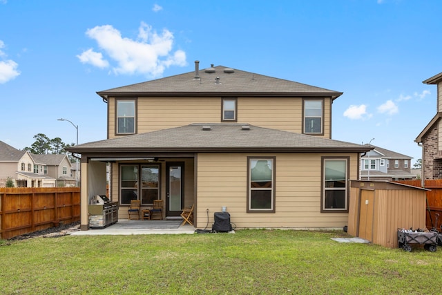 rear view of house with a patio area and a lawn