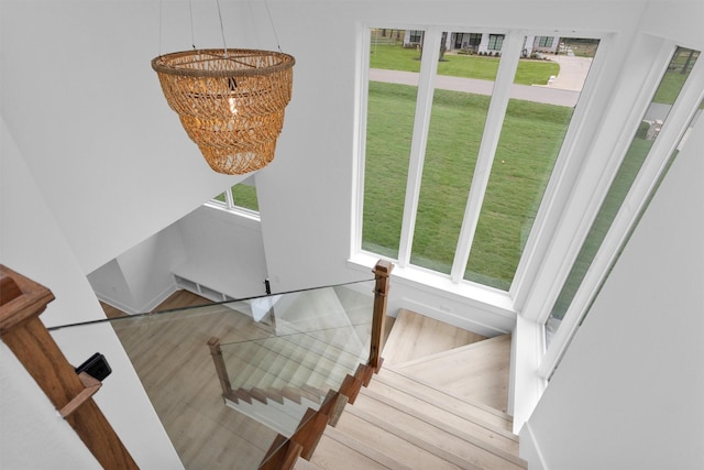 19918 Live Oak Bnd, Magnolia, TX 77355 - stairs with a healthy amount of sunlight and an inviting chandelier