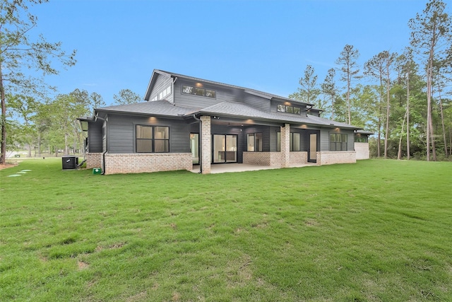 19918 Live Oak Bnd, Magnolia, TX 77355 - rear view of property featuring a patio, brick siding, central air condition unit, and a yard