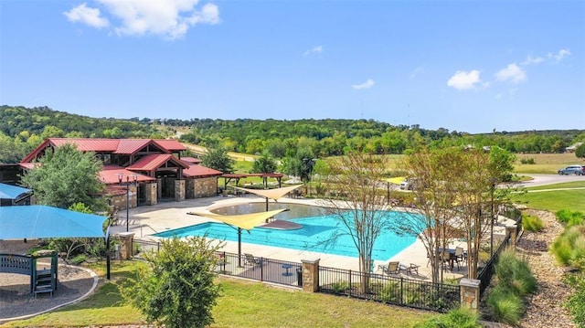 view of pool with a patio area and a yard