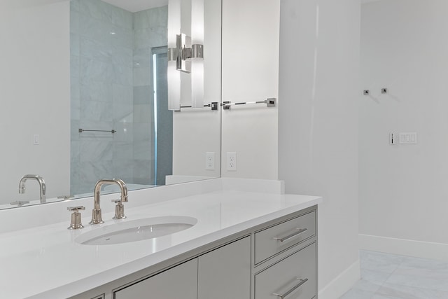 bathroom featuring vanity and tiled shower