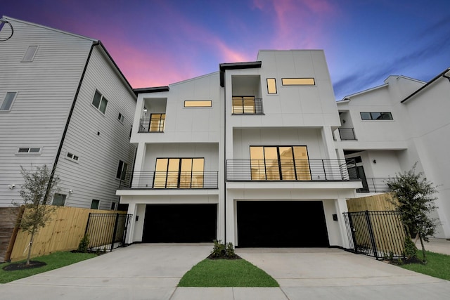 contemporary home with a garage and a balcony