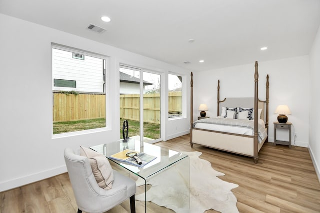 bedroom featuring light wood-type flooring and access to outside