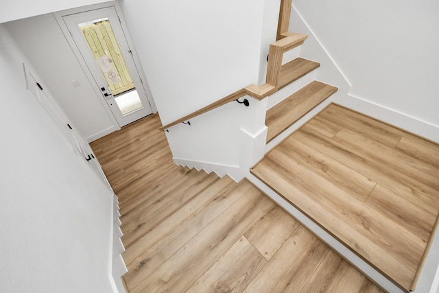 staircase with wood-type flooring