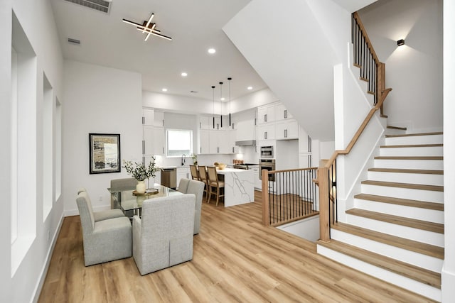 dining room with light hardwood / wood-style flooring and sink