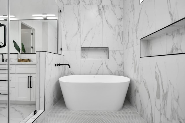 bathroom featuring a washtub and vanity