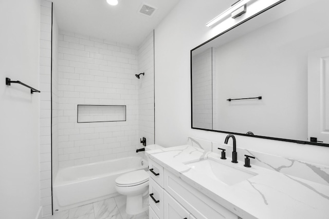 full bathroom with tiled shower / bath combo, vanity, and toilet