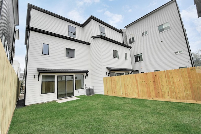 back of property featuring a yard and cooling unit