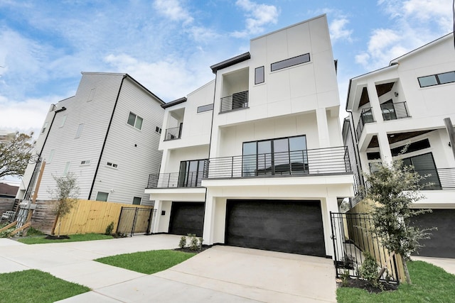 view of front of house featuring a garage and a balcony