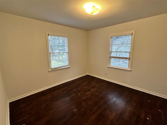 unfurnished room with hardwood / wood-style flooring